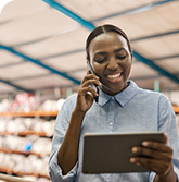 Person on phone looking at tablet